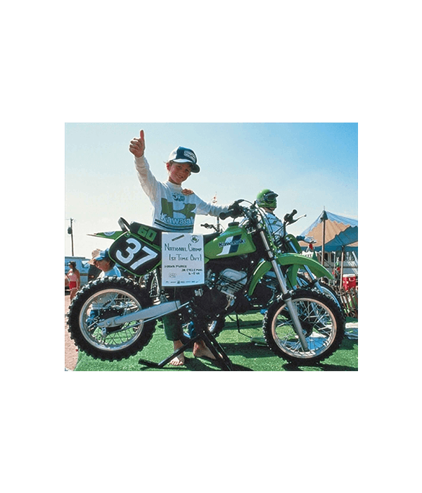 8-year-old “Hammerin” Hank Moree poses next to the first-ever KX™60 (1983 pre-production) mini-bike.